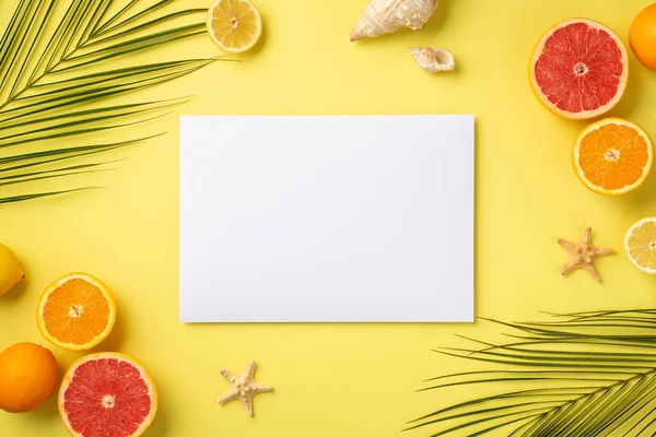 Summer vacation concept. Top view photo of paper card tropical fruits cut oranges lemons grapefruits shells starfishes and green palm leaves on isolated yellow background with blank space