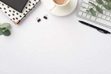 Business concept. Top view photo of workplace keyboard black and white stationery diaries pen binder clips cup of coffee on saucer and eucalyptus on isolated white background with copyspace clipart