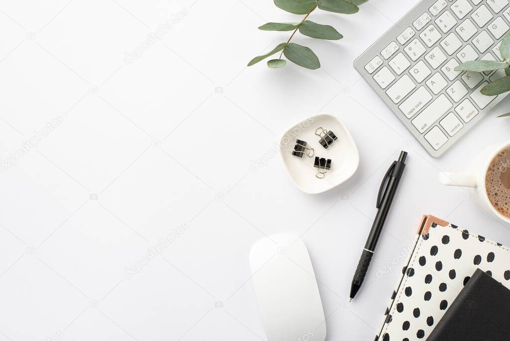 Business concept. Top view photo of workplace keyboard computer mouse black and white trendy note pads pen binder clips cup of coffee and eucalyptus on isolated white background