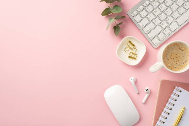 Business concept. Top view photo of workstation keyboard computer mouse cup of hot drinking wireless earbuds binder clips pen reminders eucalyptus leaves on isolated pink background with empty space