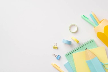 Back to school concept. Top view photo of school supplies pencil-case notebooks stand for pens binder clips and adhesive tape on isolated white background with copyspace