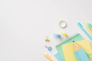 Back to school concept. Top view photo of school accessories pencil-case notepads pens binder clips and adhesive tape on isolated white background with copyspace