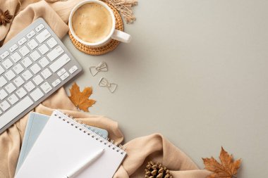 Autumn business concept. Top view photo of reminders pen bow shaped clips keyboard cup of coffee on rattan serving mat anise fallen maple leaves pine cone and plaid on isolated grey background