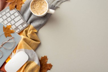 Autumn business concept. Top view photo of workstation yellow maple leaves keyboard computer mouse planner glasses cup of hot drinking and plaid scarf on isolated grey background with copyspace