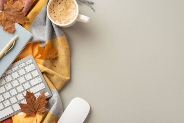 Autumn business concept. Top view photo of keyboard computer mouse notepad pen cup of frothy coffee yellow maple leaves and plaid on isolated grey background with copyspace