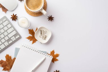 Autumn business concept. Top view photo of keyboard computer mouse planner pen candle cup of hot drinking rattan serving mat binder clips yellow maple leaves and anise on isolated white background