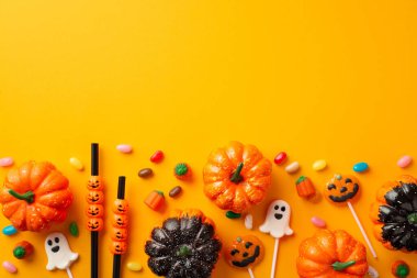 Halloween party accessories concept. Top view photo of pumpkins straws ghost shaped lollipops and candies on isolated orange background with copyspace