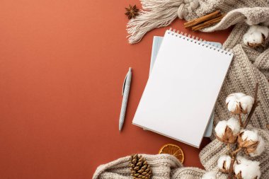 Kış konsepti Açık planlı eşarp kalemi, kurutulmuş portakal dilimi anason tarçın çubukları ve kopyalanmış kahverengi arka planda pamuk dalının en üst görüntüsü.