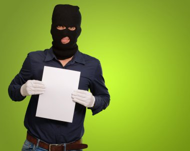 Man wearing a robber mask showing a blank paper clipart