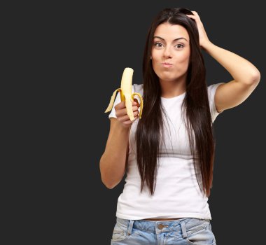 A Young Woman Eating A Banana