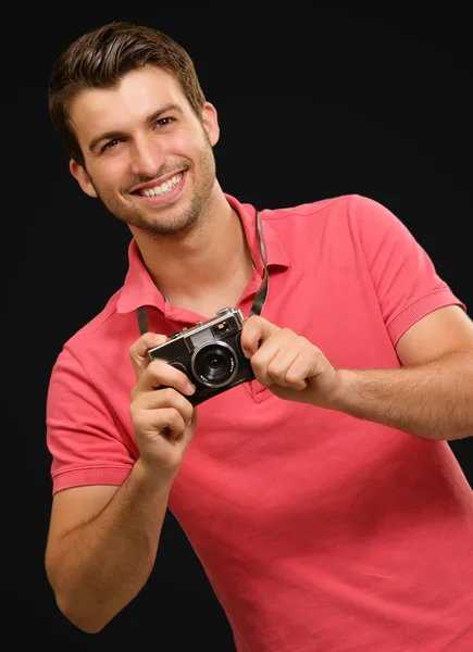 Portrait of a man holding camera — Stock Photo, Image