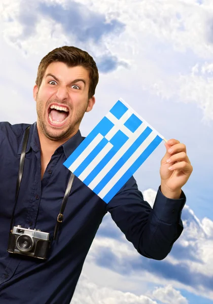 Homem segurando bandeira e avião em miniatura — Fotografia de Stock