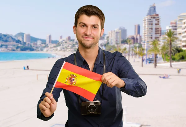 Portrait of a young man holding a flag — Stock Photo, Image
