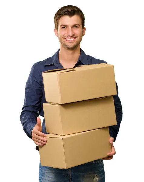 Un joven sosteniendo una pila de cajas de cartón — Foto de Stock