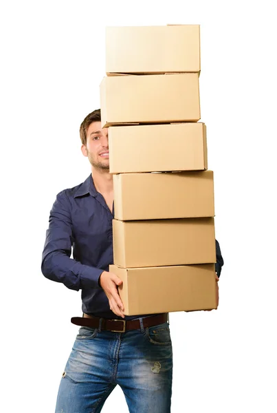 Un joven sosteniendo una pila de cajas de cartón — Foto de Stock