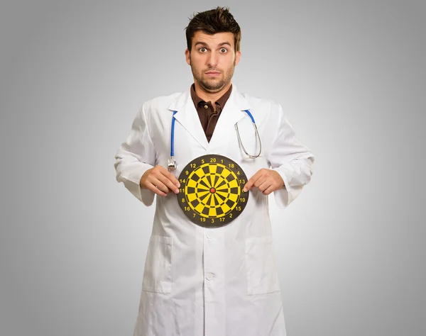 Portrait Of Young Doctor Holding A Dartboard — Stock Photo, Image