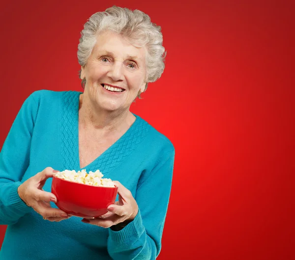 Seniorin hält Popcorn in der Hand — Stockfoto