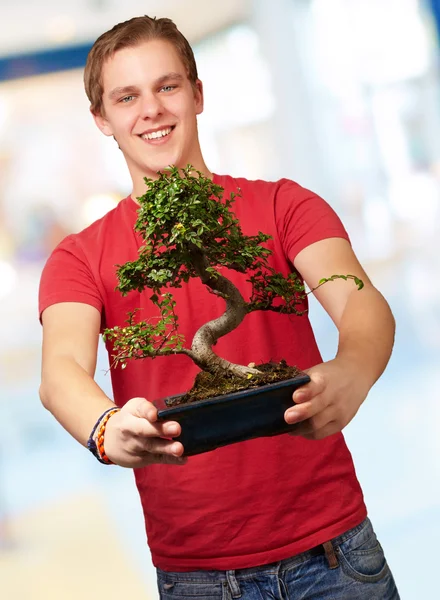 Portrait of a young man holding a pot — Stock Photo, Image