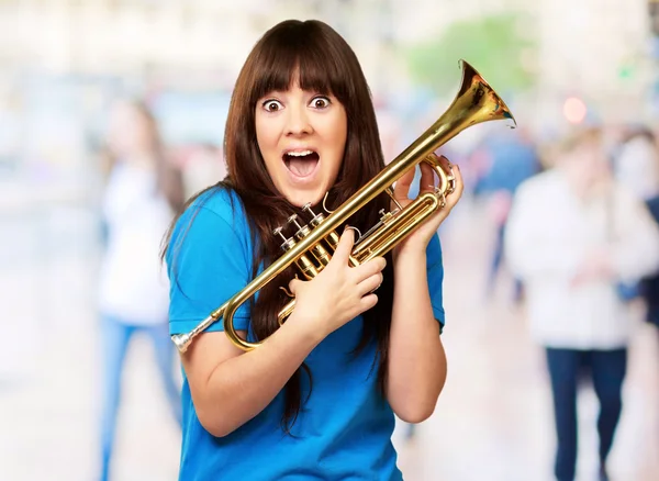 Surprised woman holding trumpet — Stock Photo, Image