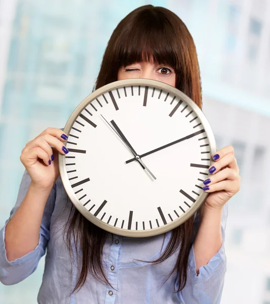 Woman Holding Clock Winking — Stock Photo, Image