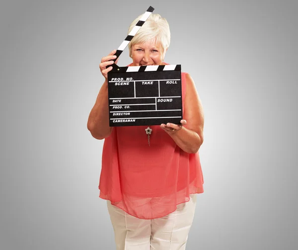 Senior Woman Holding Clapper — Stock Photo, Image