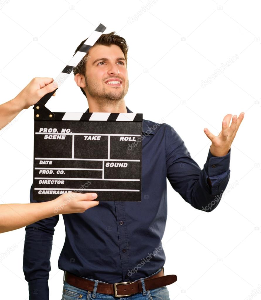 A Young Man Holding A Clapboard And Acting