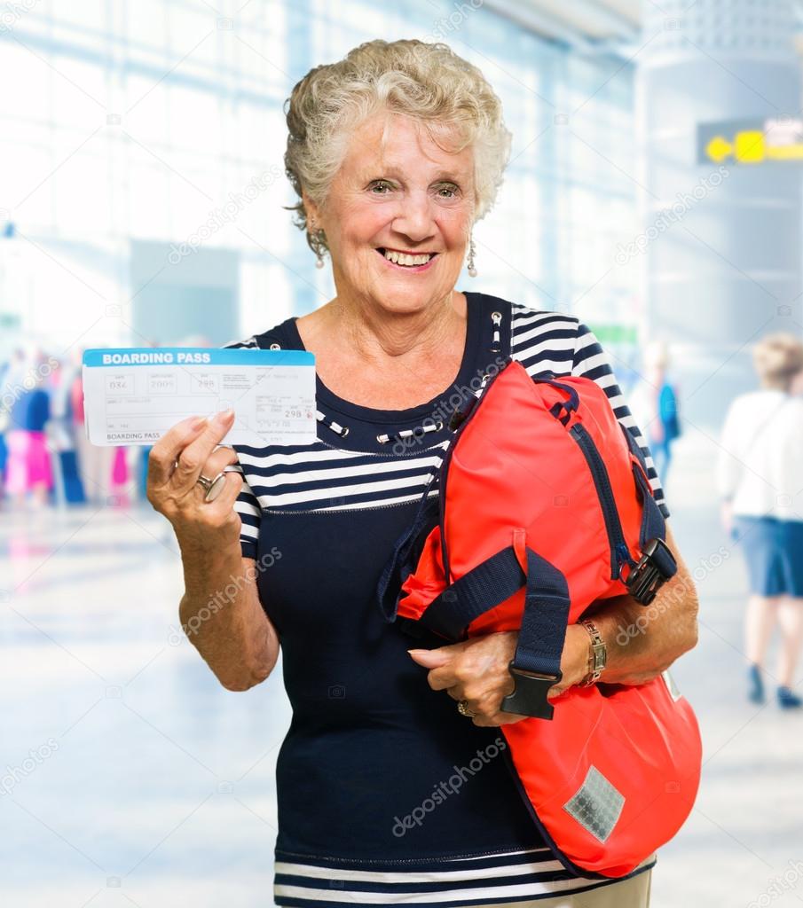 Woman Holding Boarding Pass And Luggage