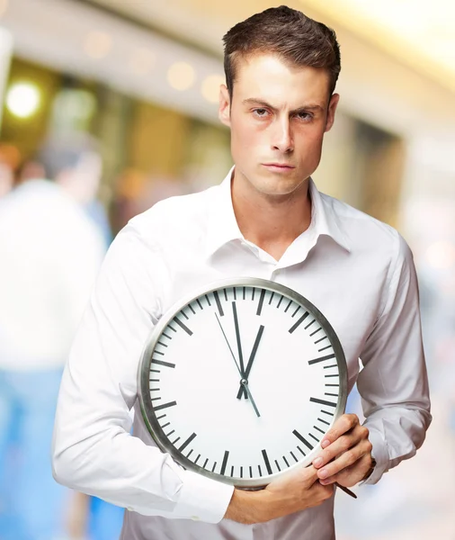 Irritado homem segurando um relógio — Fotografia de Stock