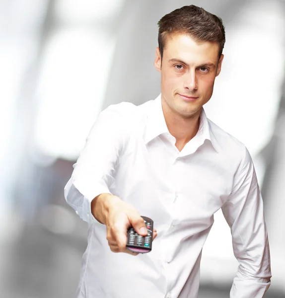 Man Holding Remote In His Hand — Stock Photo, Image