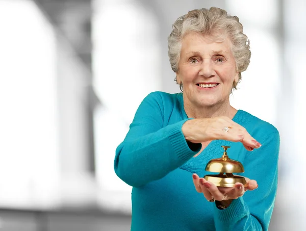 Happy Mature Woman While Holding Bell — Stock Photo, Image