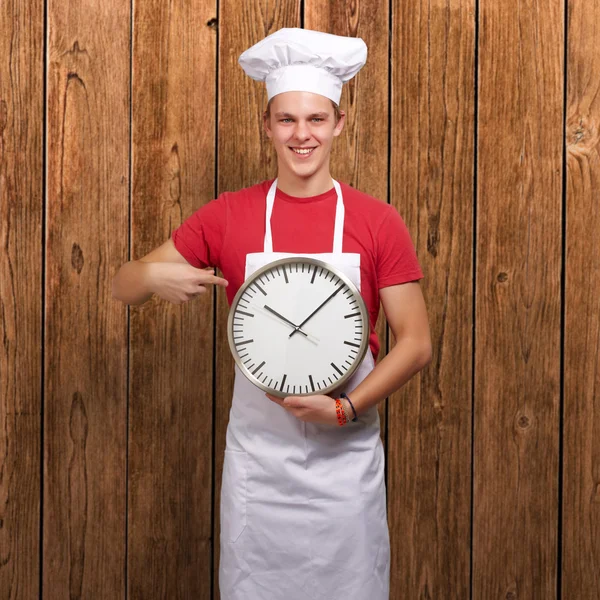 Portrait Of A Young Man Holding A Clock — Stock Photo, Image