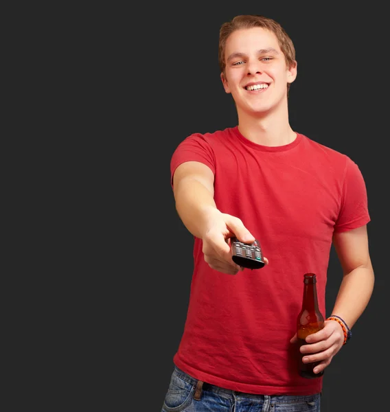 Portrait of a young man with remote control — Stock Photo, Image