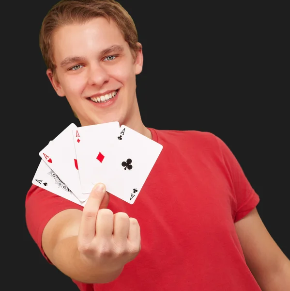 Portrait of a young male holding four aces — Stock Photo, Image