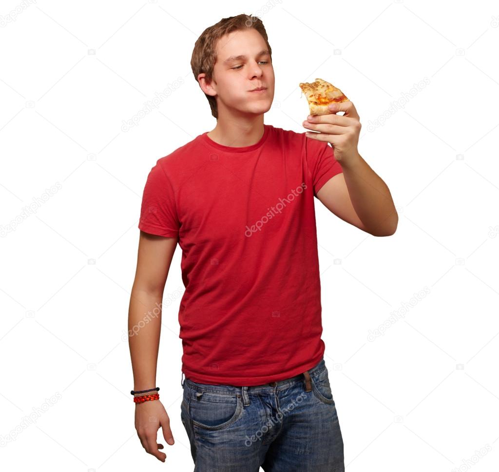 portrait of a young man eating pizza