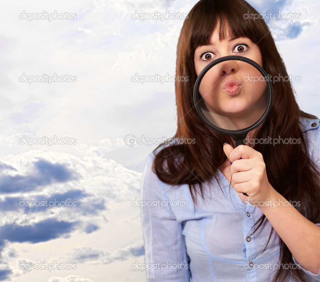 Woman Holding Magnifying Glass On Mouth