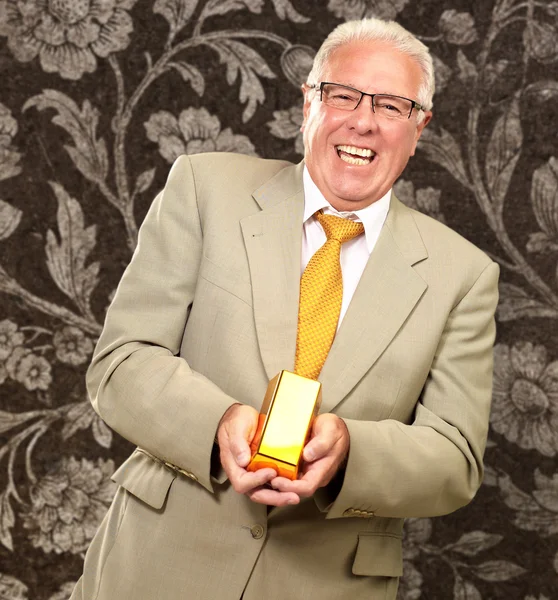 Senior Man Holding Gold Bar — Stock Photo, Image