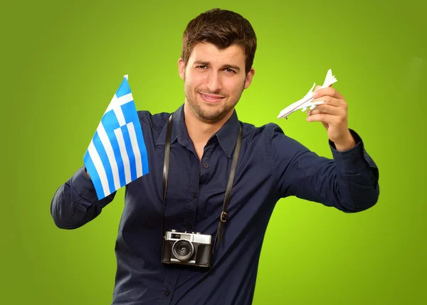 Man Holding A Miniature Airplane And Greece Flag — Stock Photo, Image