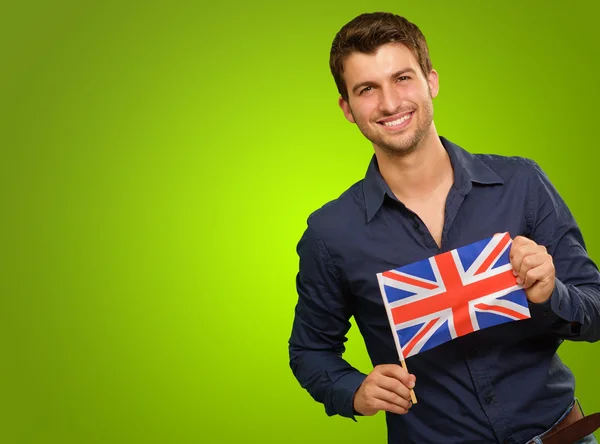 Młody człowiek trzyma flagę z Wielka Brytania — Zdjęcie stockowe