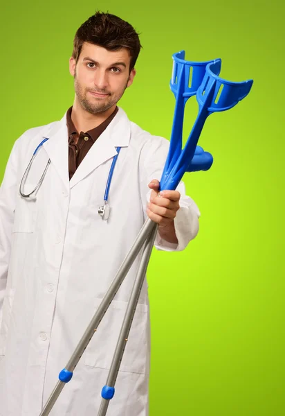 Portrait Of A Doctor Holding Crouches — Stock Photo, Image