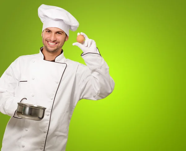 Chef macho sosteniendo una olla y huevo — Foto de Stock