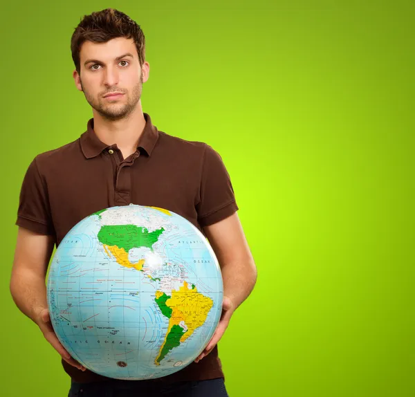 Giovane uomo Holding Globe — Foto Stock