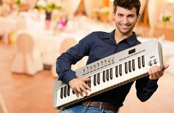 Young Man Holding Piano — Stock Photo, Image