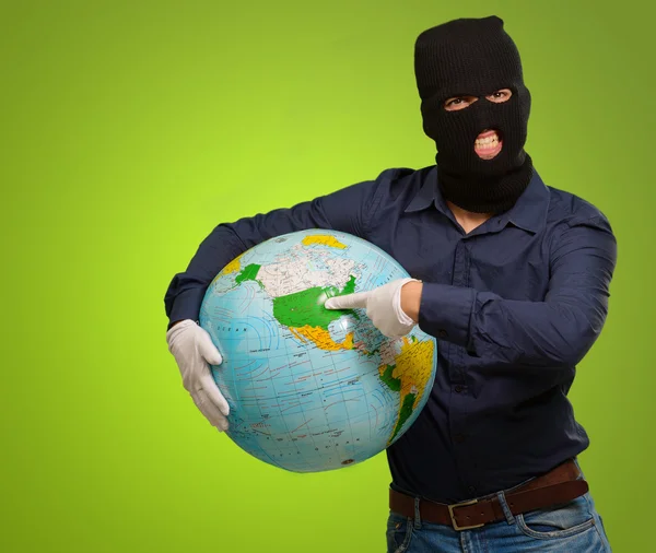 Young Man Masked Holding Globe — стоковое фото