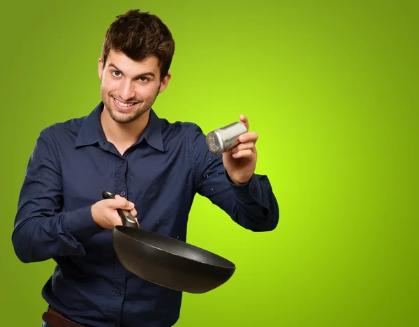 Portrait Of A Man Cooking Isolated On Geen Background — Stock Photo, Image