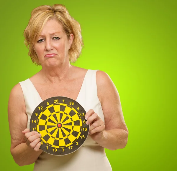 Sad Mature Woman Holding Dartboard — Stock Photo, Image