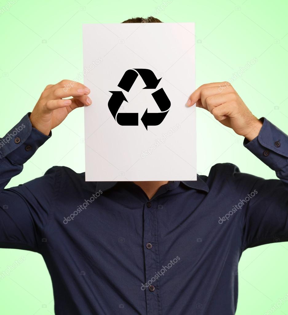 Young Man Holding A Recyclable Symbol In Front Of Face