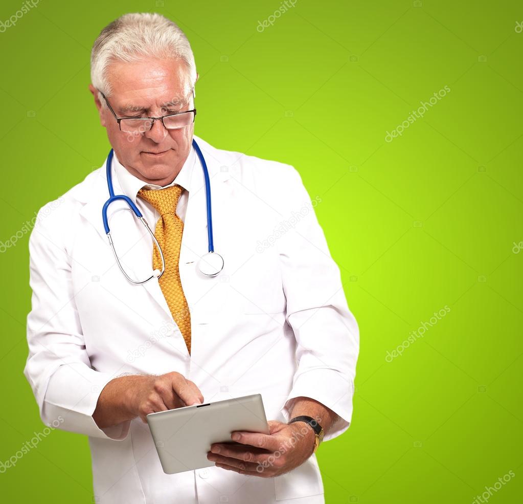 Senior Male Doctor Using Digital Tablet