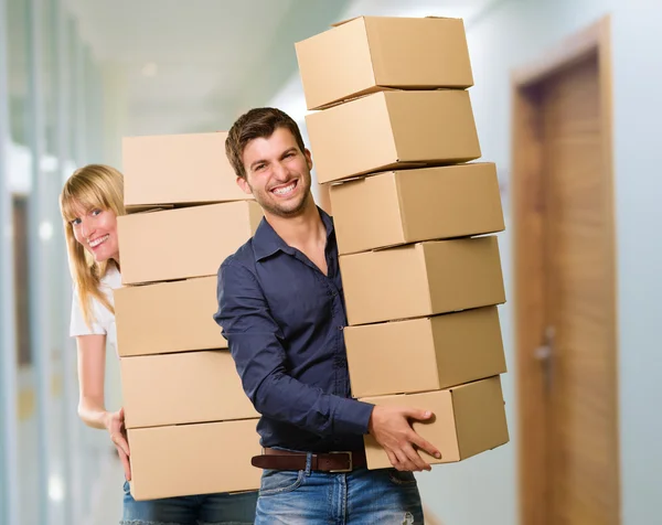 Man And Woman Holding Stack Of Cardboard — Stock Photo, Image