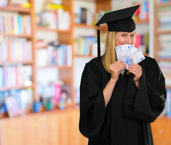 Graduate woman holding euro notes — Stock Photo, Image