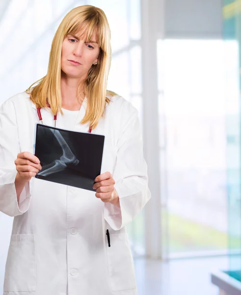 Serious doctor looking at an x-ray — Stock Photo, Image